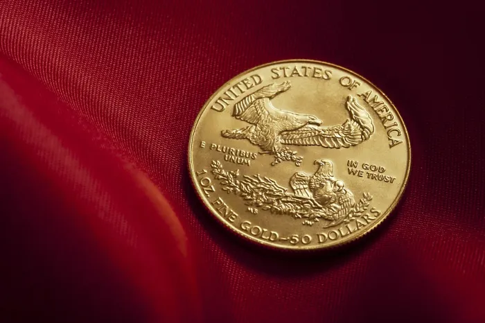 Framed Print : Gold coin with eagle design placed on rich red fabric