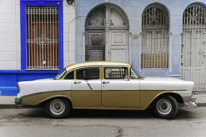 Framed Print : A gold-white vintage car stands in front of a stylish house facade Framed Print : A gold-white vintage car stands in front of a stylish house facade