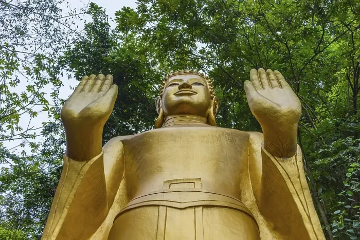 Framed Print : Golden Buddha statue with raised hands