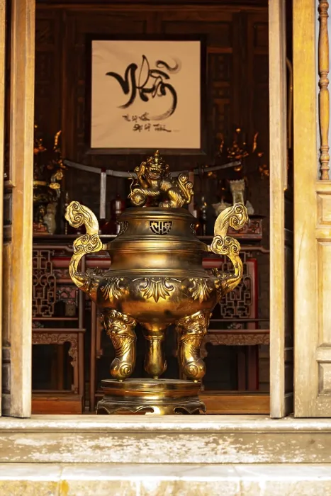 Framed Print : Golden incense burner prominently displayed in a traditional temple interior