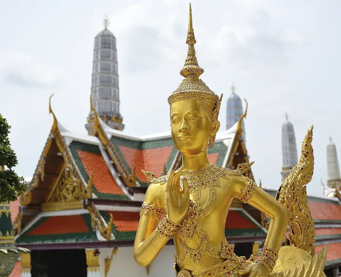 Framed Print : Golden kinnara statue praying with hands joined in a traditional thai greeting
