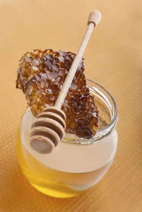 Framed Print : Golden organic honey in glass jar on golden honey comb Framed Print : Golden organic honey in glass jar on golden honey comb