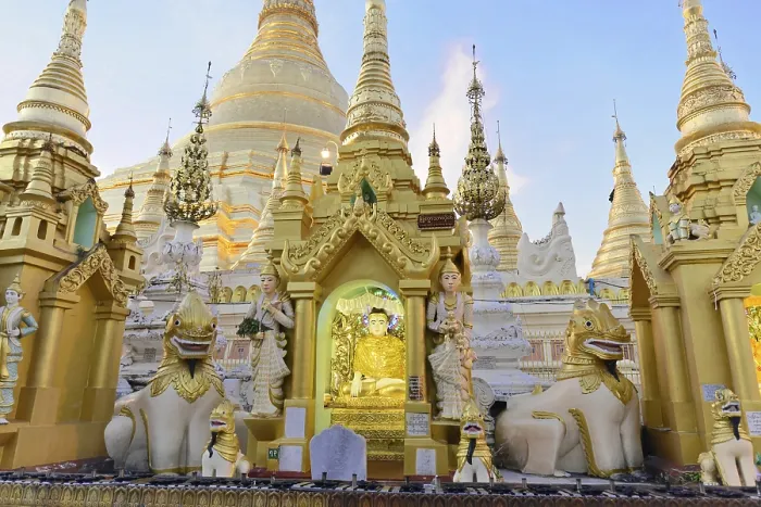 Framed Print : Golden sculptures and carved figures in front of a pagoda