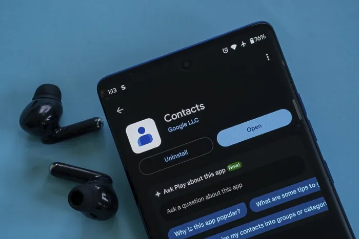 Framed Print : Google Contacts app displayed on a phone with nearby earbuds Framed Print : Google Contacts app displayed on a phone with nearby earbuds