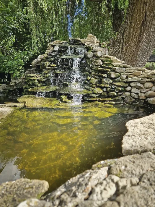 Framed Print : Graceful spring with cascades over moss-covered stones into a crystal-clear pond with thrown coins Framed Print : Graceful spring with cascades over moss-covered stones into a crystal-clear pond with thrown coins