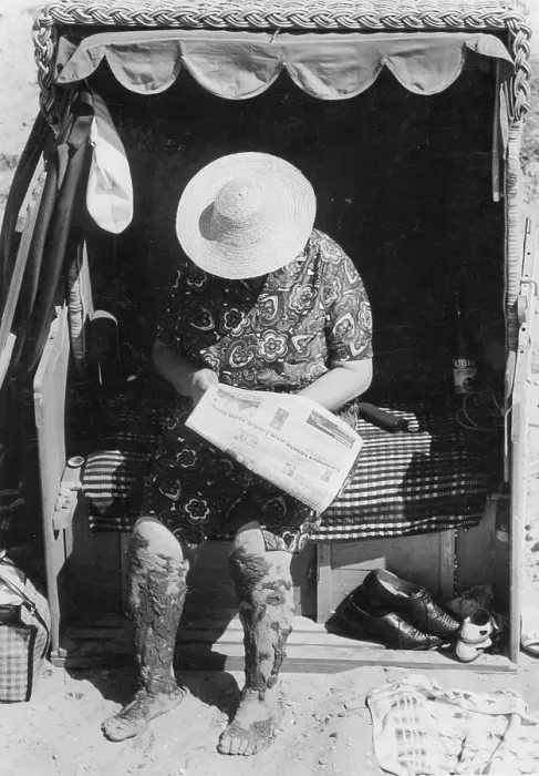 Framed Print : Grandma reads newspaper in a beach chair