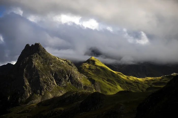 Framed Print : Grassy mountains with light mood and threatening clouds
