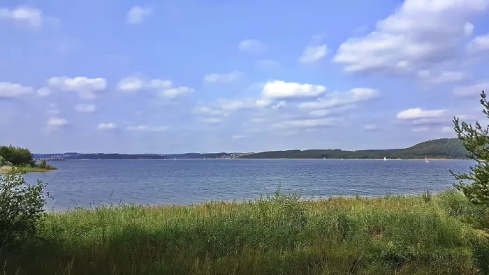 Framed Print : Grassy shore overlooking peaceful lake Framed Print : Grassy shore overlooking peaceful lake