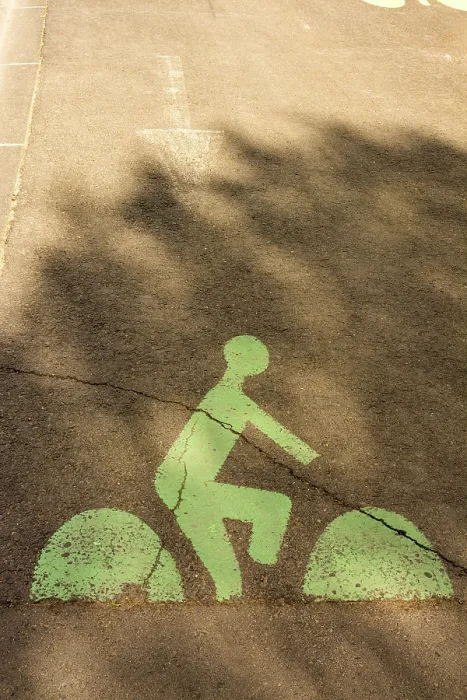 Framed Print : A green bicycle lane marking is visible on a city street