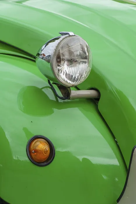 Framed Print : Green bodywork of a vintage car with a striking headlight design