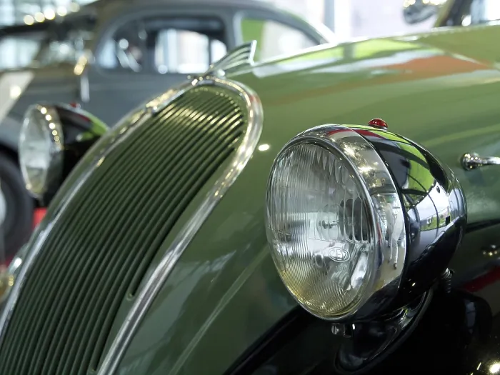 Framed Print : Green classic car with striking round headlights and chrome details