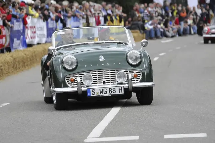 Framed Print : A green classic roadster drives on a road at a classic car race