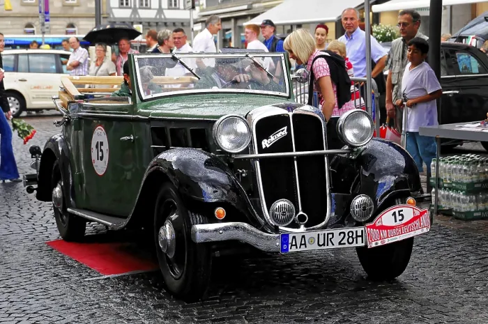 Framed Print : Green convertible classic car in an urban environment at an event with people and light rain Framed Print : Green convertible classic car in an urban environment at an event with people and light rain