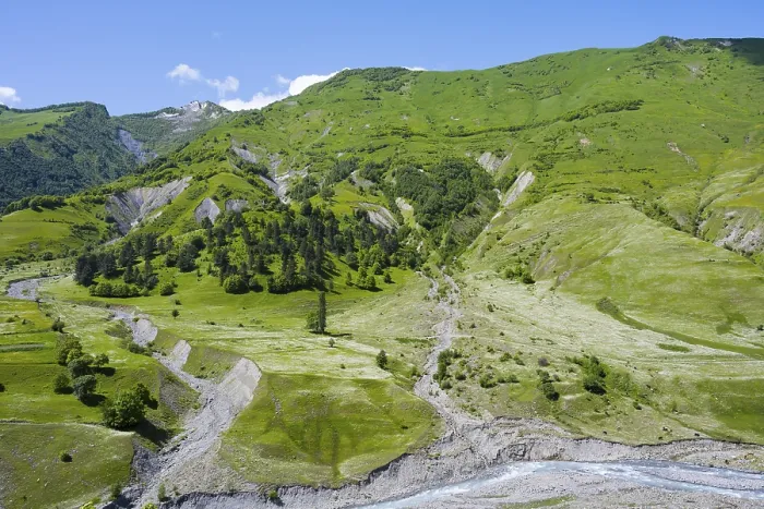 Framed Print : Green hills with a valley and river