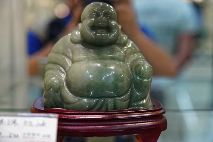 Framed Print : Green jade figure of a laughing Buddha on a pedestal