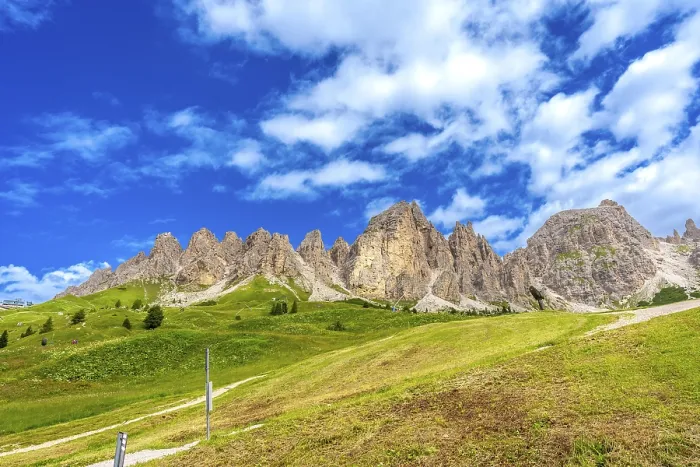 Framed Print : Green meadows and imposing peaks of the dolomites illuminated by the summer sun Framed Print : Green meadows and imposing peaks of the dolomites illuminated by the summer sun
