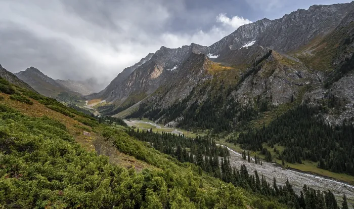 Framed Print : Green mountain valley with river and steep mountain peaks