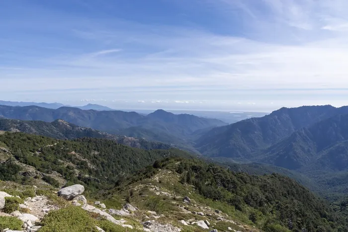 Framed Print : Green mountains and valleys stretching towards the horizon under a clear blue sky in Corsica