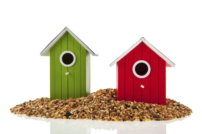 Framed Print : Green and red birdhouses with seed for birds