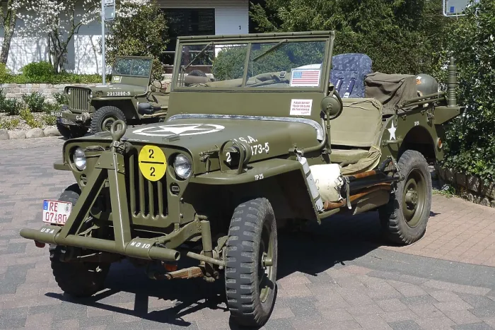 Framed Print : Green vintage jeep with military markings parked on a paved area Framed Print : Green vintage jeep with military markings parked on a paved area