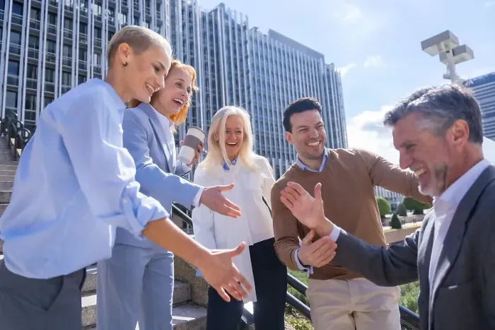 Framed Print : Greeting each other coworker. Group of executives or business people outdoors in a corporate office area