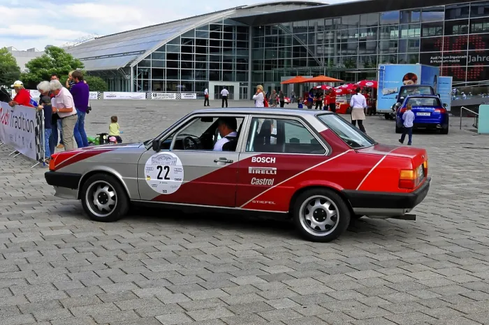 Framed Print : Grey-red car at a vintage car event with modern architecture in the background