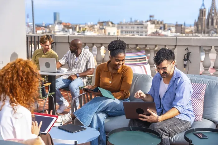 Framed Print : Group of diverse business people meeting and working together casually on a rooftop terrace