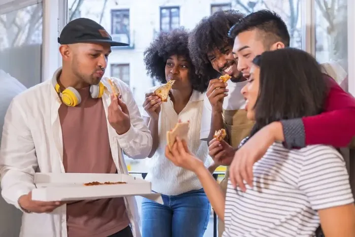Framed Print : Group of friends eating pizza on the terrace at home