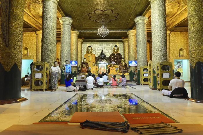Framed Print : Group of people meditating in richly decorated temple room with pillars Framed Print : Group of people meditating in richly decorated temple room with pillars