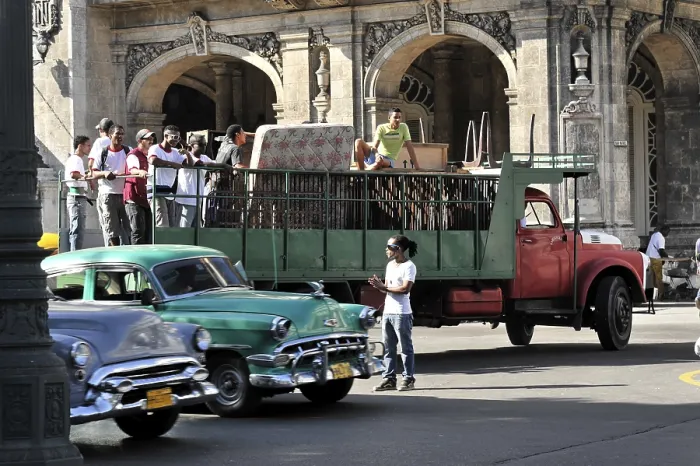 Framed Print : Group of people preparing to board a vintage city bus