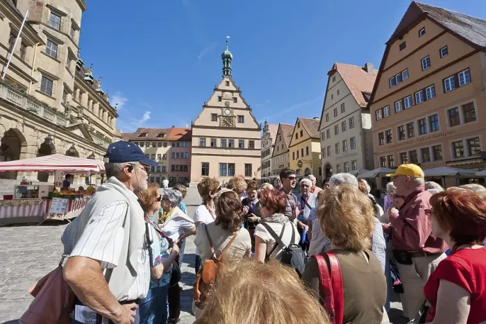Framed Print : Group of tourists with a tour guide on the market square Framed Print : Group of tourists with a tour guide on the market square