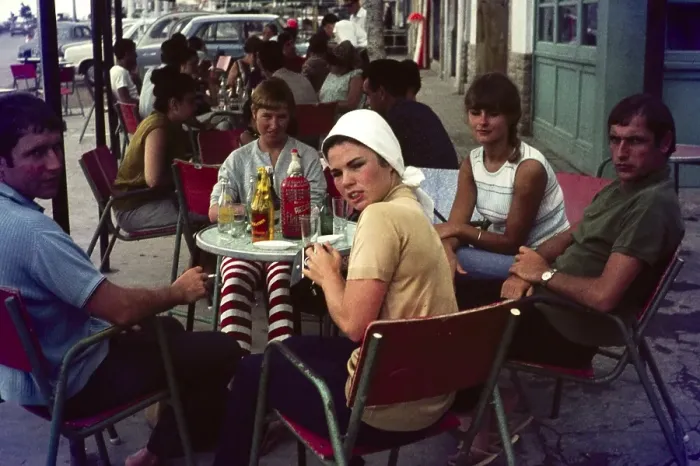 Framed Print : Group of young British people on holiday sitting around a cafe table, Spain, 1966, Europe