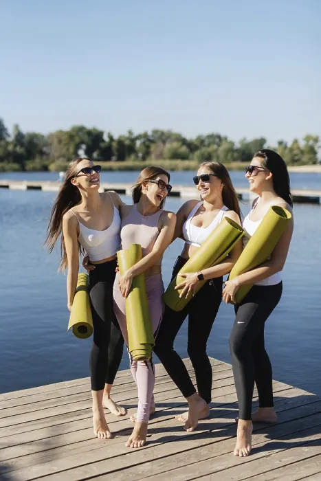 Framed Print : Group of young girls doing yoga outdoors and near the water