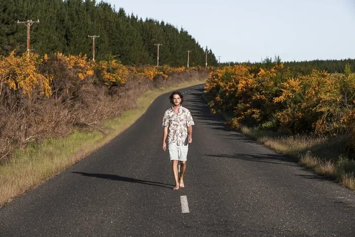 Framed Print : Guy walking on a road, Rotorua