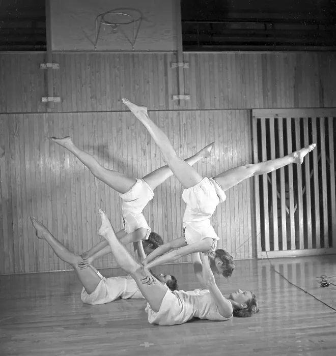 Framed Print : Gymnastics in the 1940s. Four young female gymnasts are practicing together and doing the same movement Framed Print : Gymnastics in the 1940s. Four young female gymnasts are practicing together and doing the same movement