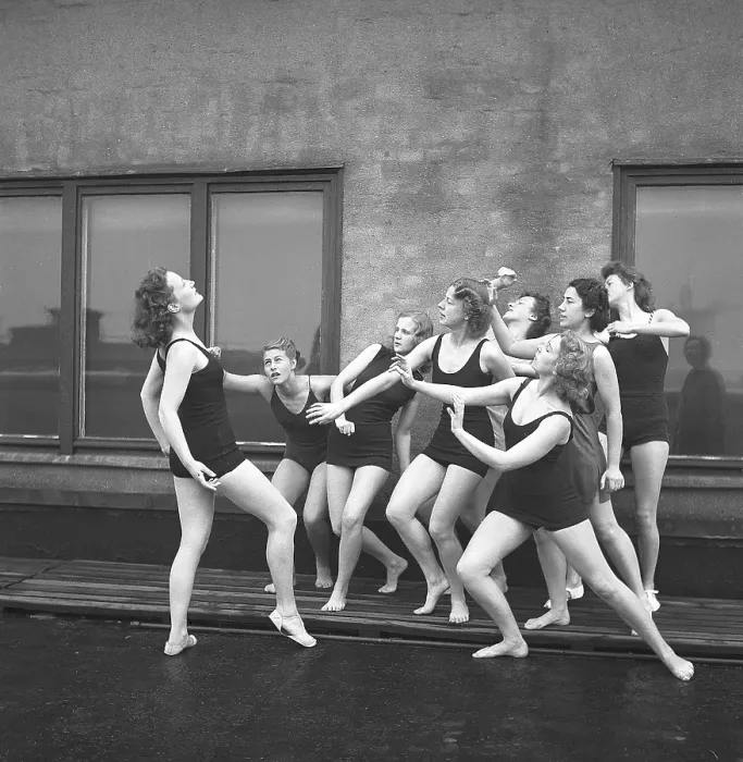 Framed Print : Gymnasts in the 1940s. A group of women gymnasts are training together on a top of a building Framed Print : Gymnasts in the 1940s. A group of women gymnasts are training together on a top of a building
