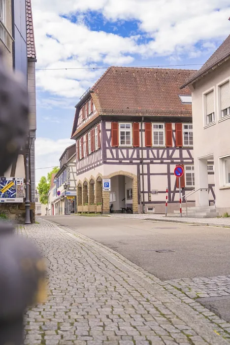 Framed Print : Half-timbered building on a cobbled street under a blue sky Framed Print : Half-timbered building on a cobbled street under a blue sky