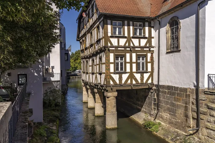 Framed Print : Half-timbered hospital building on piles in the water