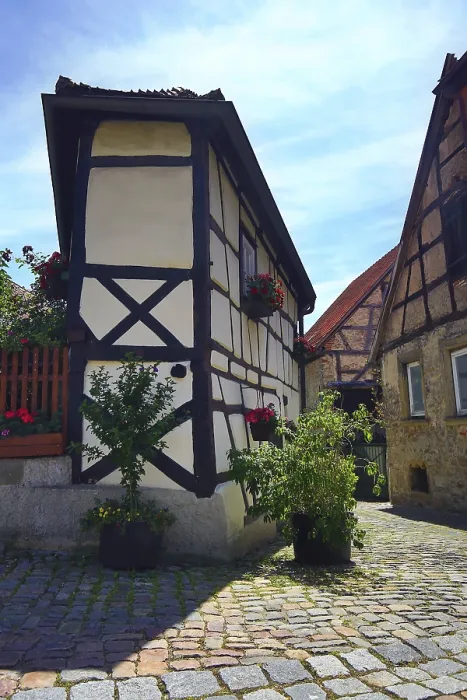 Framed Print : Half-timbered house with blooming plants and historic cobblestones in Bad Wimpfen Framed Print : Half-timbered house with blooming plants and historic cobblestones in Bad Wimpfen
