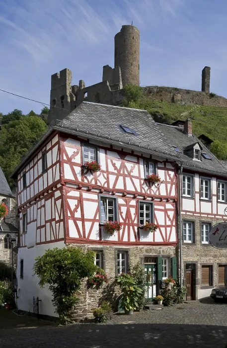 Framed Print : Half-timbered house and castle ruins