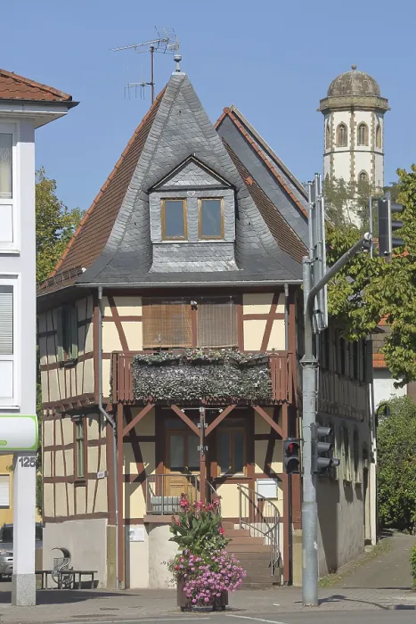 Framed Print : Half-timbered house and church tower of the Gothic collegiate church of the Benedictine monastery