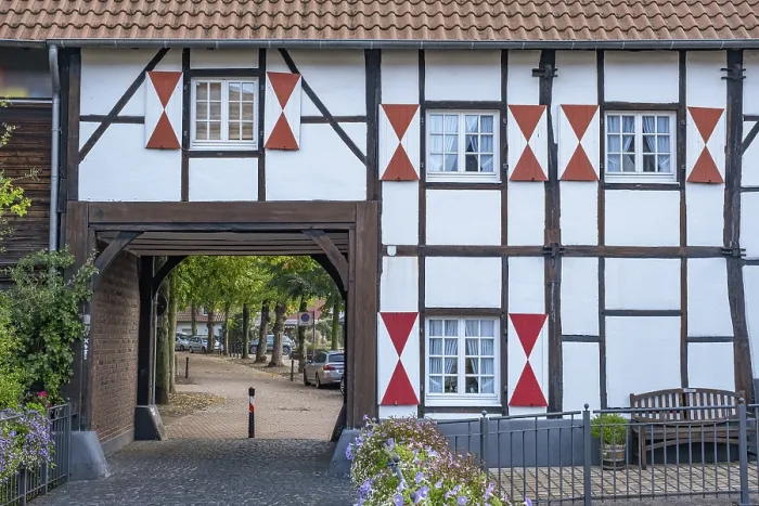 Framed Print : A half-timbered house with red brick detail and a large archway Framed Print : A half-timbered house with red brick detail and a large archway