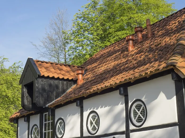 Framed Print : Half-timbered house with round window and tiled roof in a rural setting Framed Print : Half-timbered house with round window and tiled roof in a rural setting