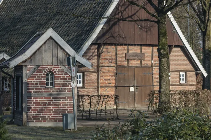 Framed Print : Half-timbered house with tiled roof surrounded by trees in a wintery atmosphere