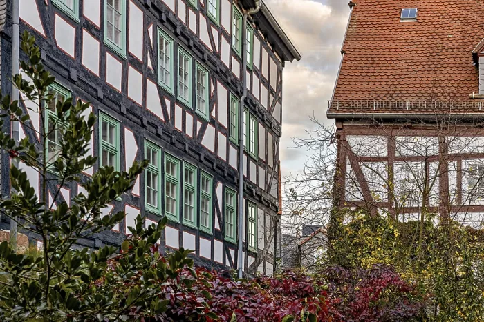 Framed Print : Half-timbered houses with green shutters and autumn vegetation Framed Print : Half-timbered houses with green shutters and autumn vegetation