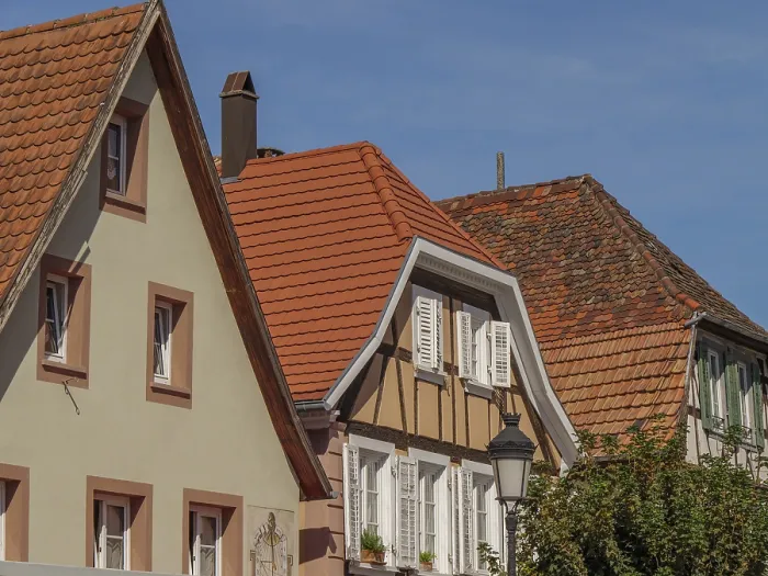 Framed Print : Three half-timbered houses with red tiled roofs and white shutters under a blue sky Framed Print : Three half-timbered houses with red tiled roofs and white shutters under a blue sky