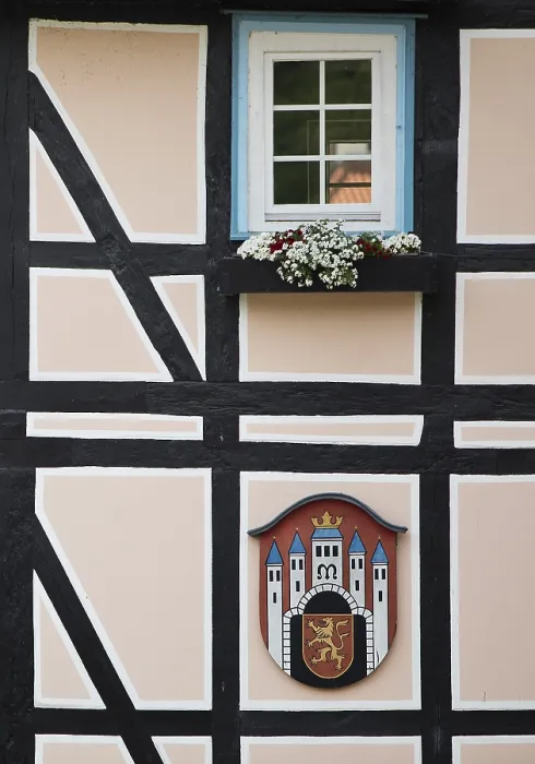 Framed Print : Half-timbered houses with town coat of arms