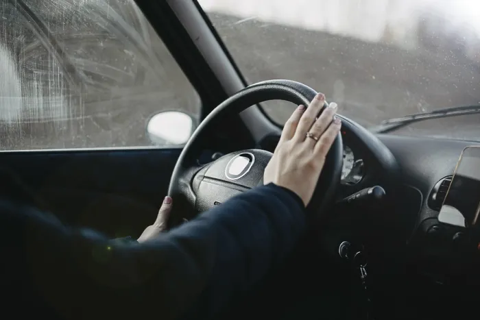 Framed Print : Hand resting on a steering wheel as if about to press the horn