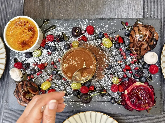 Framed Print : Hand with spoon tasting a dessert Framed Print : Hand with spoon tasting a dessert