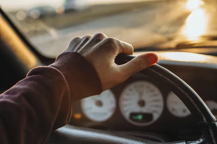 Framed Print : A hand on a steering wheel inside a car with a sunset view outside Framed Print : A hand on a steering wheel inside a car with a sunset view outside